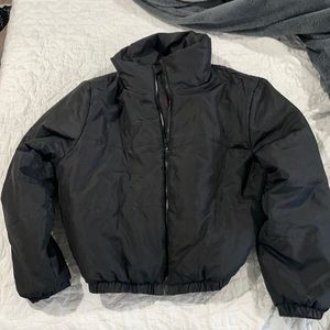 Women’s black zip-up puffer jacket